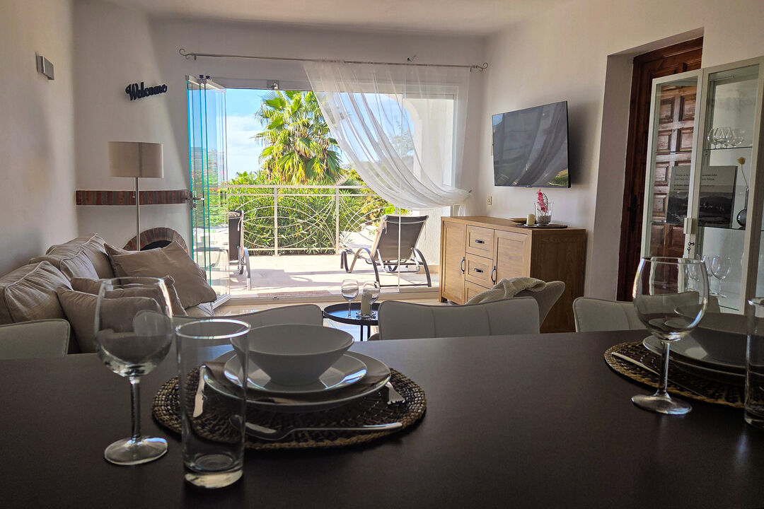 The large glass front opens up the living room to the terrace ...